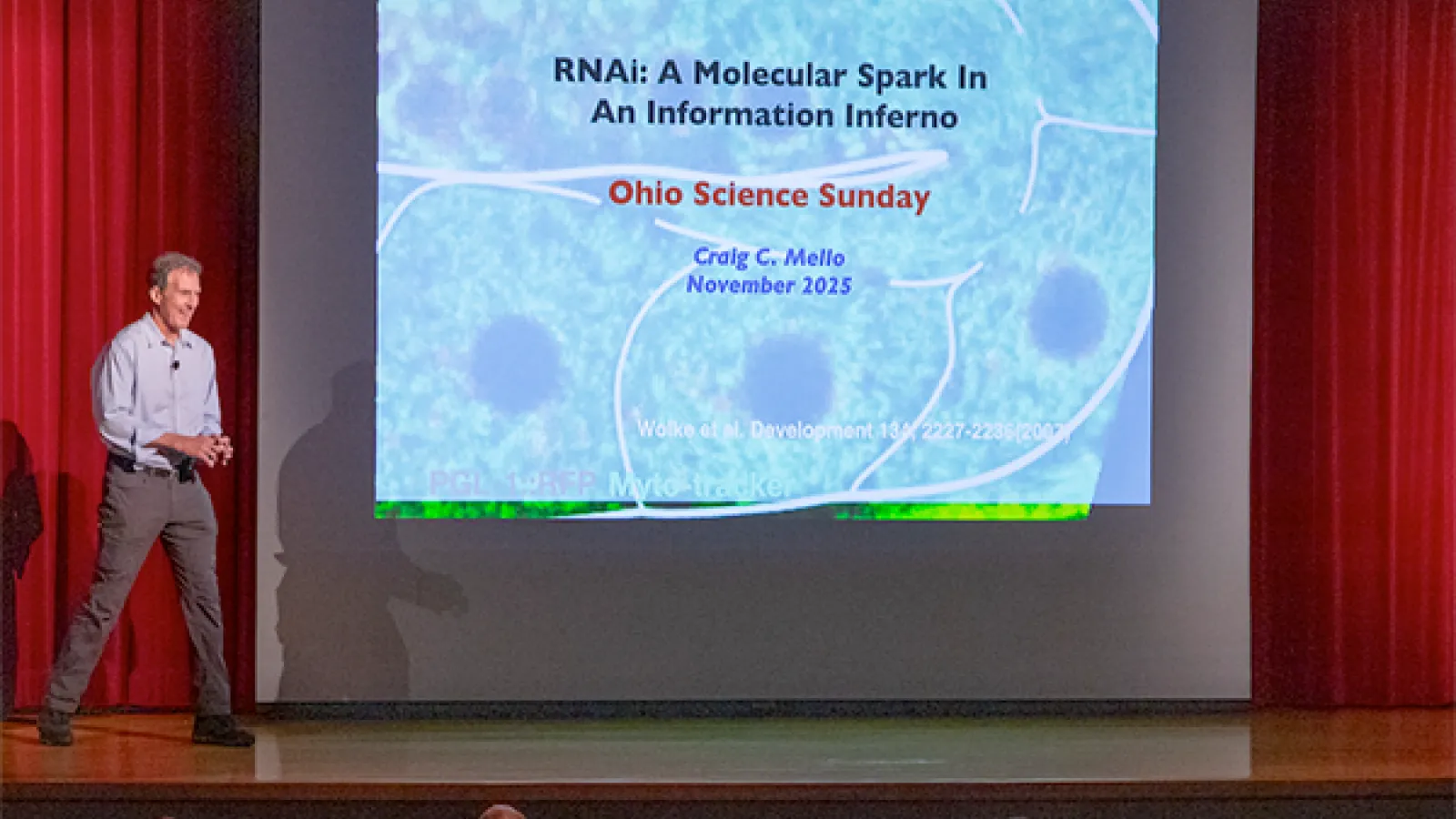 Dr. Craig Mello walking on stage to deliver the Science Sunday leccture