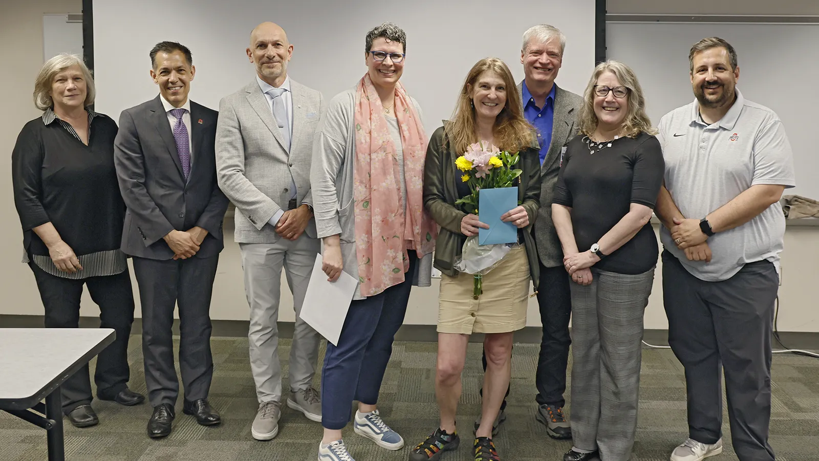 Amanda surrounded by the people who came to surprise her with the award