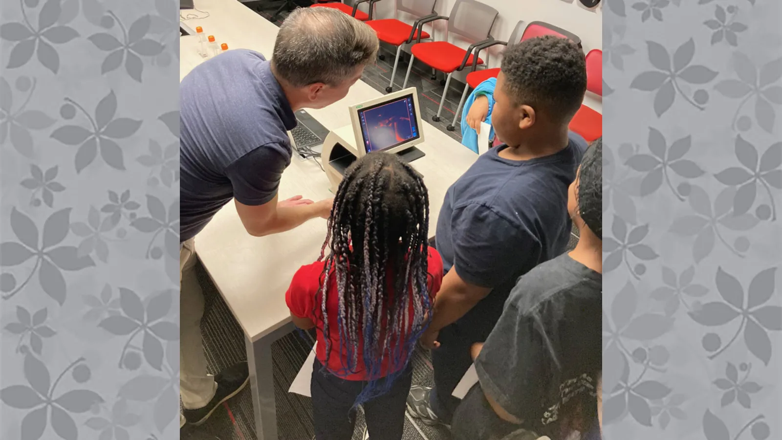 Visitors looking at fluorescent zebrafish