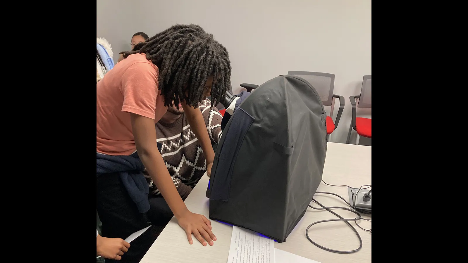 Visitor looking in a microscope