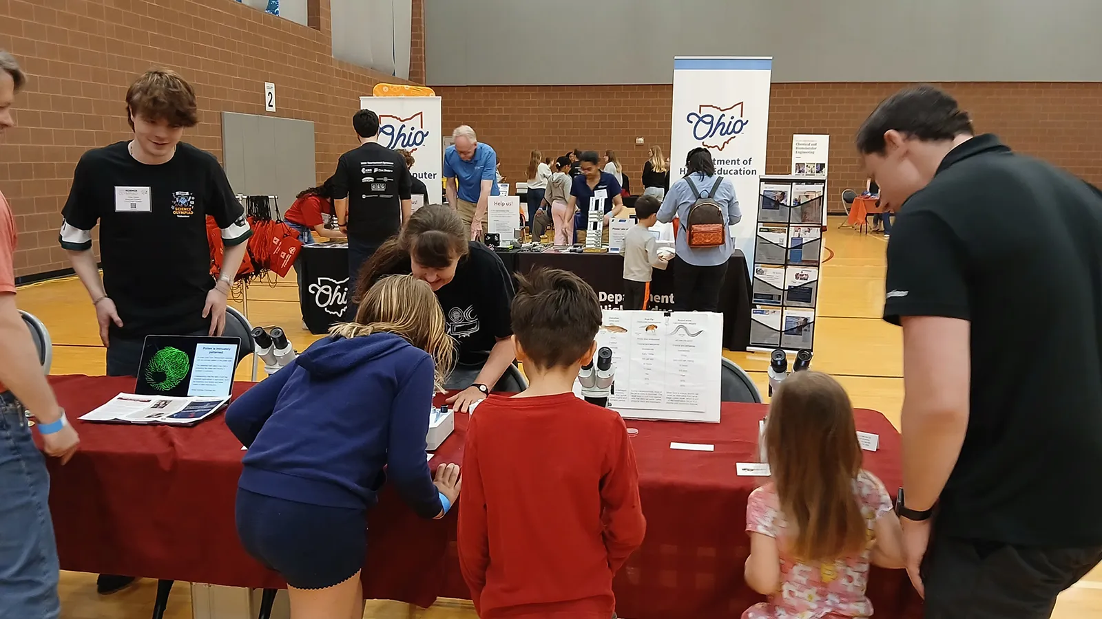 Excited visitors looking in microscopes