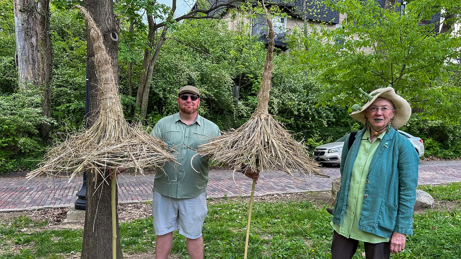 Instructors Norman Groves and Iris Meier carrying straw trichomes in the Earth Day Parads
