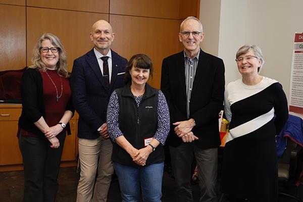 Sharon Amacher (center) with administrators at the surprise announcement