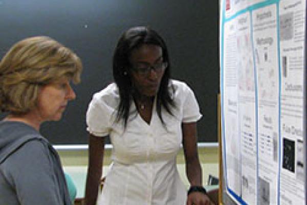 REU student presenting a scientific poster REU student presenting a scientific poster
