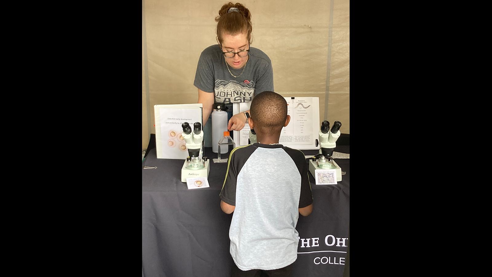 A young man learning about zebra fish.