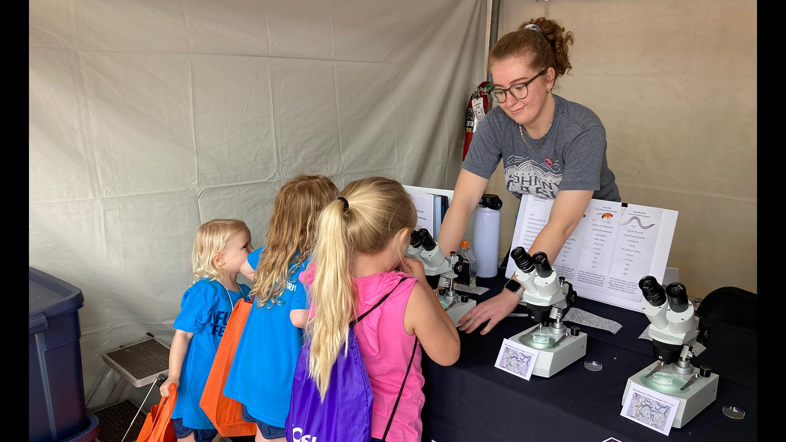 Children getting to look through microscopes