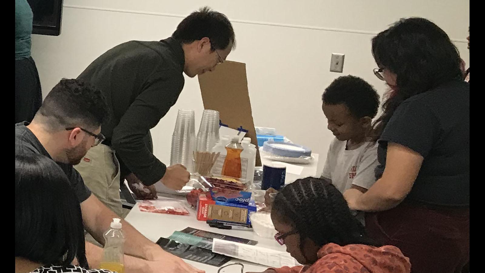 Mol Gen Faculty teaching youngsters about DNA extraction