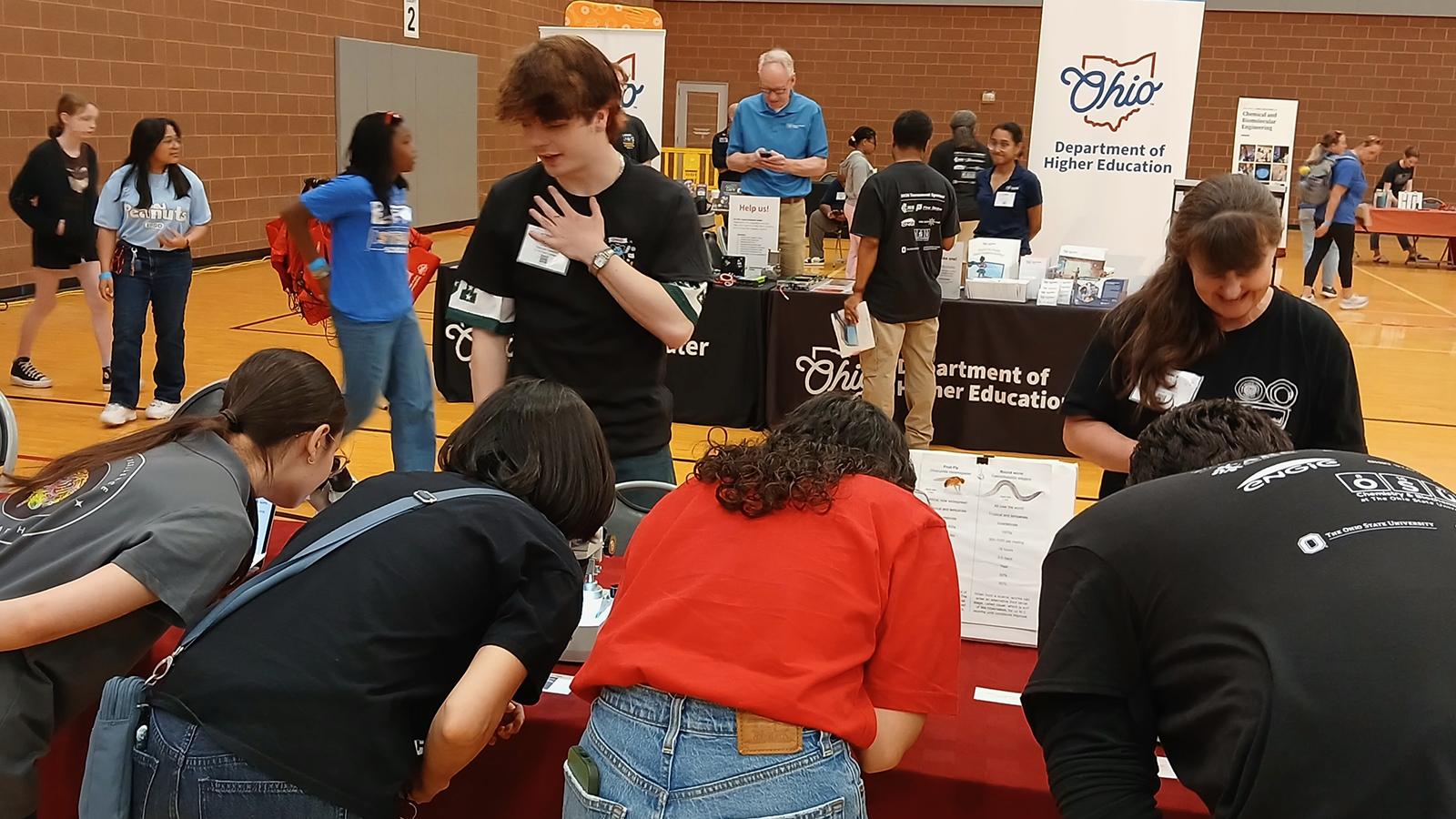 Visitors looking in Microscopes