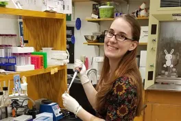 Mol Gen graduate student working at her lab station